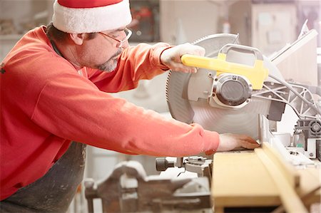 quality in bussines - Cabinet maker using circular saw in workshop Stock Photo - Premium Royalty-Free, Code: 614-08065908