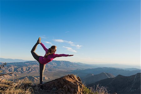 stretching (people exercising) - Young female trail runner in yoga pose on rock, Pacific Crest Trail, Pine Valley, California, USA Stock Photo - Premium Royalty-Free, Code: 614-08066014