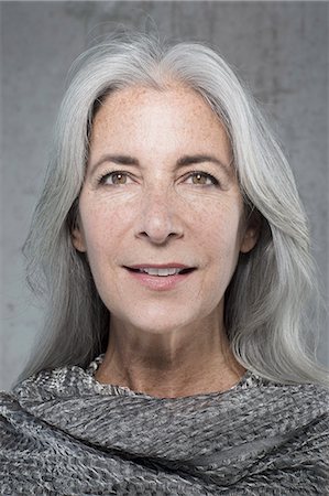 smiling 50s - Portrait of beautiful mature woman with long grey hair Stock Photo - Premium Royalty-Free, Code: 614-08066127