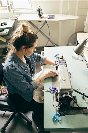 sewing - Female seamstress using sewing machine in fashion studio Stock Photo - Premium Royalty-Free, Code: 614-08119658