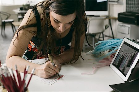 Female designer making note in design studio Stock Photo - Premium Royalty-Free, Code: 614-08119668