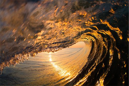 Barrelling wave, sunset, Hawaii, USA Stock Photo - Premium Royalty-Free, Code: 614-08119752