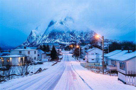 evening house - Snow covered road through at dusk, Reine, Lofoten, Norway Stock Photo - Premium Royalty-Free, Code: 614-08119994