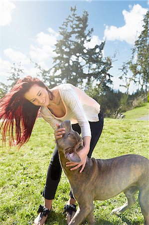 fun happy dog - Young woman petting her dog in park Stock Photo - Premium Royalty-Free, Code: 614-08126764