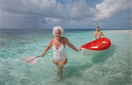 swim suits - Senior couple with canoe, Maldives Stock Photo - Premium Royalty-Free, Code: 614-08126830