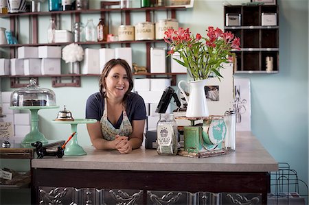 flower box - Bakery owner leaning over counter Stock Photo - Premium Royalty-Free, Code: 614-08148351