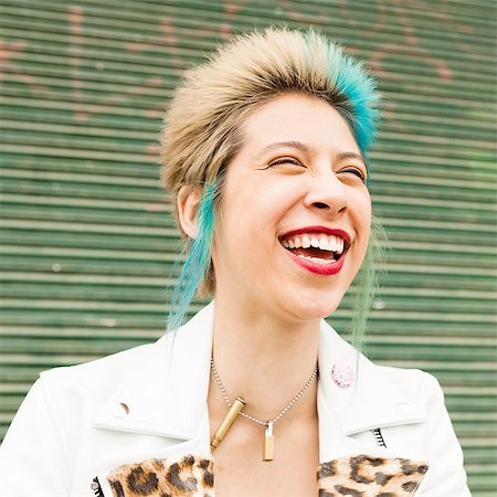 punk rocker (female) - Portrait of young woman with colourful hair, laughing, outdoors Stock Photo - Premium Royalty-Free, Code: 614-08148651