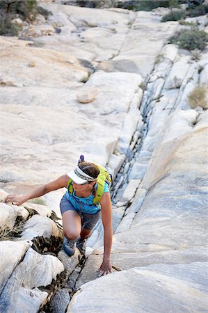 Young female rock climber climbing up crevice,  Mount Wilson, Nevada, USA Stock Photo - Premium Royalty-Free, Code: 614-08148723