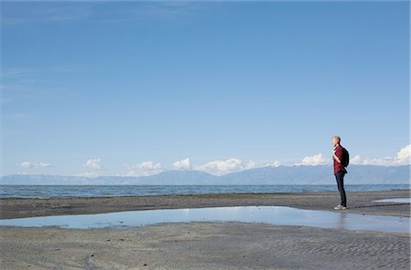 simsearch:614-06625125,k - Side view of young man standing at waters edge looking out, Great Salt lake, Utah, USA Stock Photo - Premium Royalty-Free, Code: 614-08202120