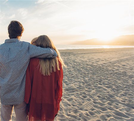 simsearch:614-06898128,k - Young couple standing on beach, hugging, rear view Stock Photo - Premium Royalty-Free, Code: 614-08202229