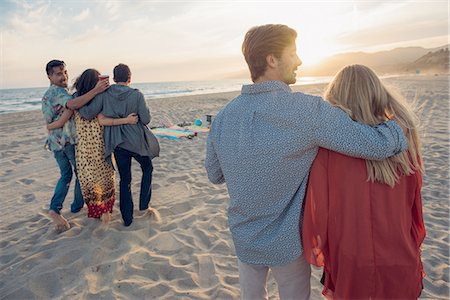 simsearch:614-05557077,k - Group of friends standing on beach, hugging, rear view Stock Photo - Premium Royalty-Free, Code: 614-08202230