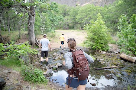 simsearch:649-08086253,k - Small group of friends hiking across stream, rear view Stock Photo - Premium Royalty-Free, Code: 614-08219873