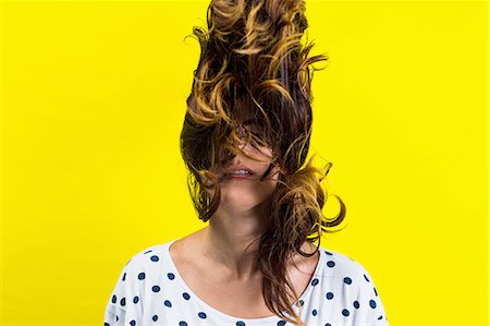 Portrait of young woman flicking hair Stock Photo - Premium Royalty-Free, Code: 614-08220181