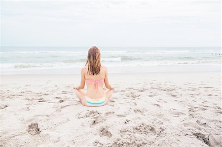 simsearch:614-05557077,k - Mid adult woman meditating on beach, rear view Stock Photo - Premium Royalty-Free, Code: 614-08270055