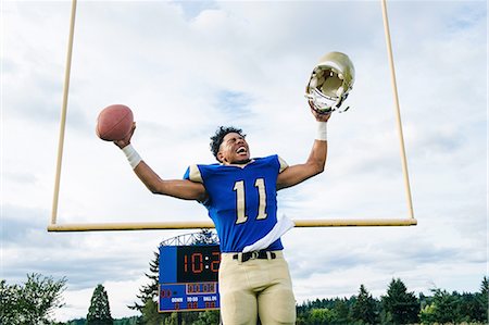 Teenage American football player celebrating on soccer pitch Stock Photo - Premium Royalty-Free, Code: 614-08270072