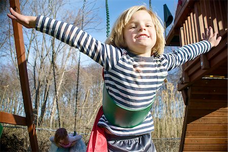 Boy with red cape pretending to fly Stock Photo - Premium Royalty-Free, Code: 614-08270160