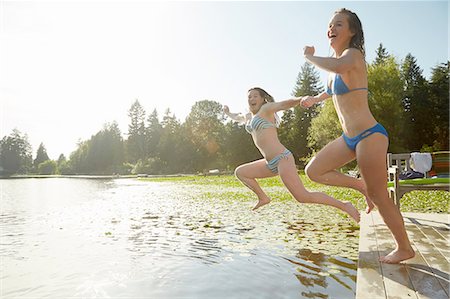 person jumping lake not dock - Girls in bikini jumping into lake, Seattle, Washington, USA Stock Photo - Premium Royalty-Free, Code: 614-08270202