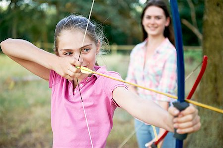 simsearch:614-08270379,k - Girl practicing archery aiming with bow and arrow Stock Photo - Premium Royalty-Free, Code: 614-08270388