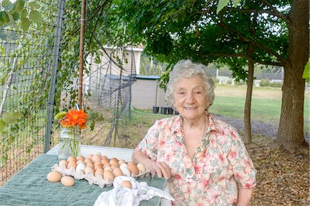 farm active - Senior woman posing beside tray of eggs on farm Stock Photo - Premium Royalty-Free, Code: 614-08307649