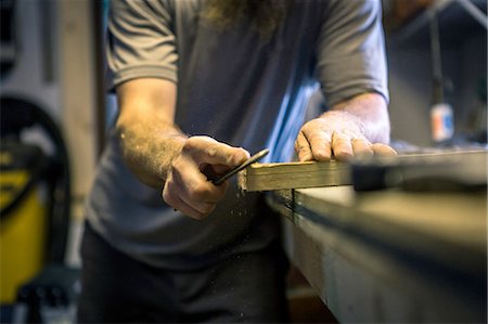 simsearch:6115-07109879,k - Wood artist working in workshop, mid section Stock Photo - Premium Royalty-Free, Code: 614-08307932