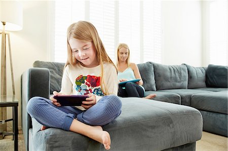 simsearch:649-07280729,k - Mother and daughter using digital tablet on sofa in living room Stock Photo - Premium Royalty-Free, Code: 614-08307980