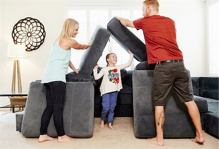 simsearch:614-06897023,k - Family stacking cushions in living room Stock Photo - Premium Royalty-Free, Code: 614-08307981