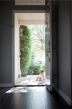 picture of open door of home - Rear view of baby boy wearing nappy crawling through open front door Stock Photo - Premium Royalty-Free, Code: 614-08308003