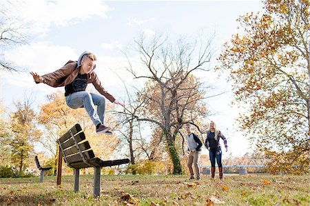simsearch:614-08270379,k - Teenage boy jumping over park bench in autumn forest Stock Photo - Premium Royalty-Free, Code: 614-08329544