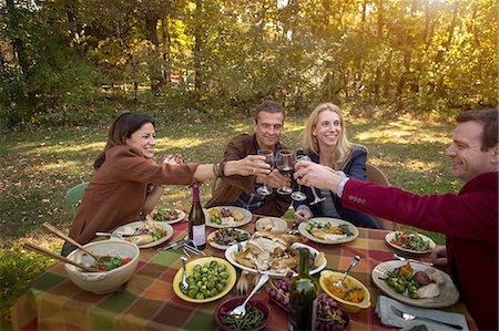 smiling couple in vegetable garden - Two mature couples making a toast over roast dinner at garden party Stock Photo - Premium Royalty-Free, Code: 614-08383575