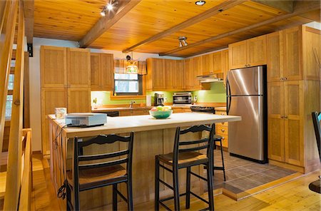 Wooden kitchen island with ceramic counter in Canadian cottage style log home Stock Photo - Premium Royalty-Free, Code: 614-08488004