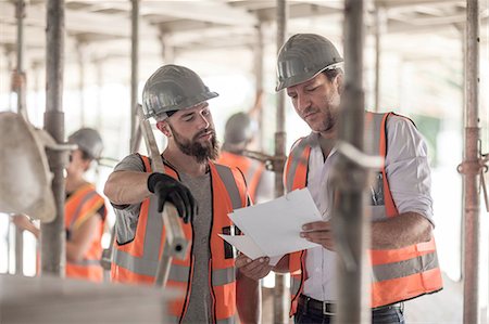 query - Male builders looking at blueprint on construction site Stock Photo - Premium Royalty-Free, Code: 614-08488054