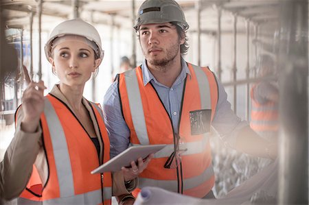 Female and male builders using digital tablet on construction site Stock Photo - Premium Royalty-Free, Code: 614-08488058