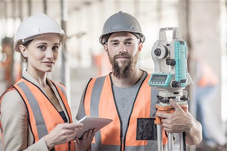 Portrait of young male and female surveyors on construction site Stock Photo - Premium Royalty-Free, Code: 614-08488074