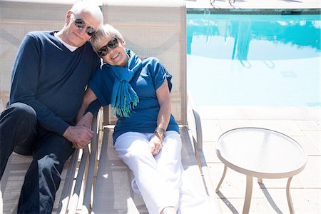 senior woman pool - Senior couple relaxing on sun loungers beside pool Stock Photo - Premium Royalty-Free, Code: 614-08535631