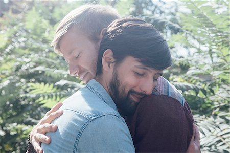 simsearch:614-02613435,k - Head and shoulder view of male couple hugging in park Stock Photo - Premium Royalty-Free, Code: 614-08535698