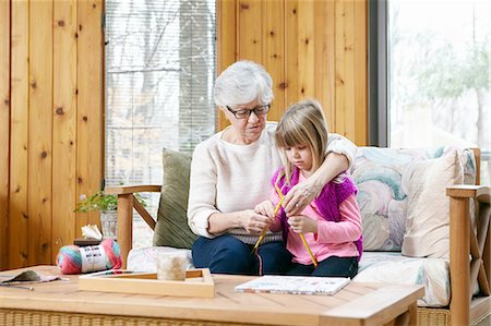 simsearch:649-03858052,k - Senior woman and granddaughter knitting together on living room sofa Stock Photo - Premium Royalty-Free, Code: 614-08535834