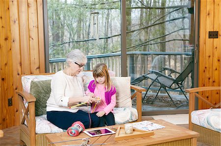 simsearch:649-03858052,k - Senior woman teaching granddaughter how to knit on living room sofa Stock Photo - Premium Royalty-Free, Code: 614-08535831