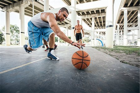 Men on basketball court reaching for basketball Stock Photo - Premium Royalty-Free, Code: 614-08544705