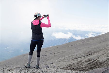simsearch:614-05557077,k - Young woman at mountain top, photographing view, rear view, Mt. St. Helens, Oregon, USA Stock Photo - Premium Royalty-Free, Code: 614-08578351