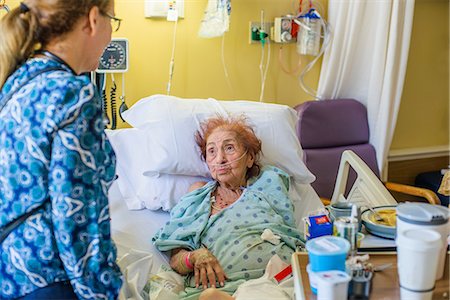 dependence - Patient on hospital bed talking to visitor Stock Photo - Premium Royalty-Free, Code: 614-08578416