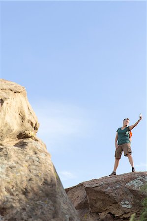 simsearch:614-07240106,k - Woman hiker standing on top of rocks using smartphone to take selfie Stock Photo - Premium Royalty-Free, Code: 614-08578816
