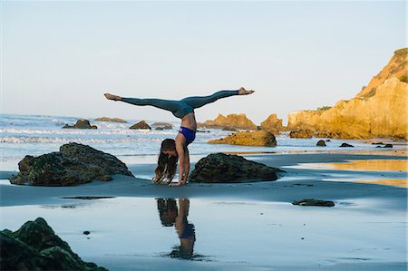 Young female dancer poised in handstand on beach, Los Angeles, California, USA Stock Photo - Premium Royalty-Free, Code: 614-08641703
