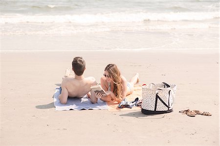 Couple relaxing on beach, Coney island, Brooklyn, New York, USA Stock Photo - Premium Royalty-Free, Code: 614-08684885