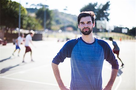 Portrait of young man on basketball court Stock Photo - Premium Royalty-Free, Code: 614-08685146