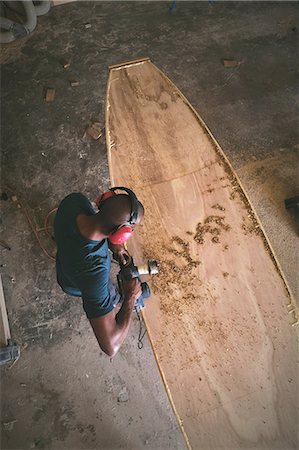 simsearch:6115-07109879,k - Craftsman making paddleboard in workshop, overhead view Stock Photo - Premium Royalty-Free, Code: 614-08726624
