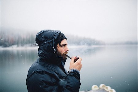 simsearch:649-08924209,k - Side view of man smoking pipe by lake, Bass Lake, California, USA Stock Photo - Premium Royalty-Free, Code: 614-08726637