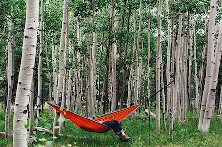 Legs of man reclining in hammock in forest, Lockett Meadow, Arizona, USA Stock Photo - Premium Royalty-Free, Code: 614-08726648