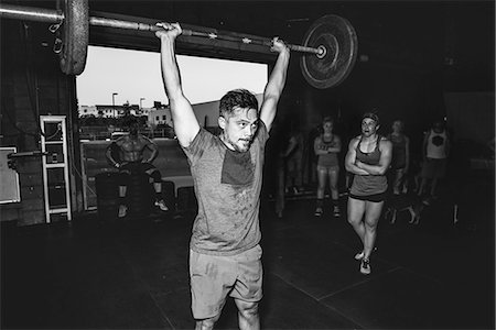 simsearch:693-08126938,k - Cross training athlete observing man lifting barbell in gym Stock Photo - Premium Royalty-Free, Code: 614-08726685