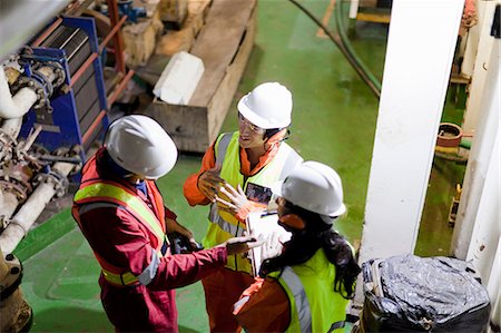 focused professional - Engineers in brainstorming session on oil rig Stock Photo - Premium Royalty-Free, Code: 614-08720688