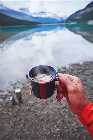 Cropped view of mans hand holding cup of tea by river, Banff, Alberta, Canada Stock Photo - Premium Royalty-Free, Code: 614-08721015